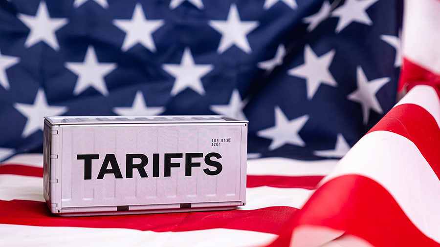 A picture of an American flag in the background, with a box that says tariffs on it.